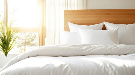 A sunlit bedroom featuring a large bed with fluffy white bedding, surrounded by natural elements including plants, creating a serene and inviting space for relaxation.