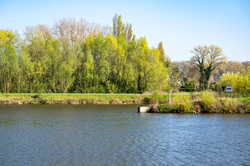 Green banks of the river Scheldt near Oudenaarde, East Flanders, Belgium