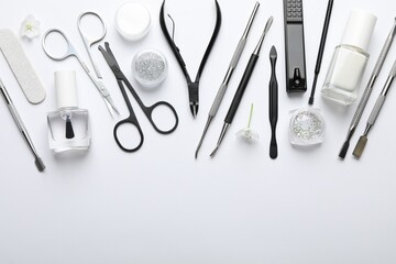 Set of different manicure tools on white background, flat lay