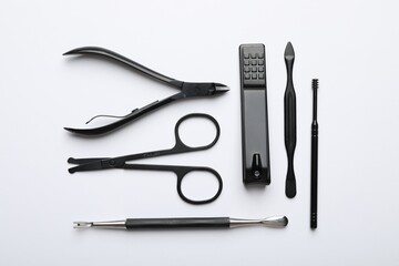 Set of different manicure tools on white background, flat lay