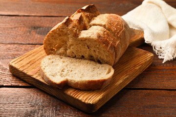 Pieces of fresh bread on wooden table, closeup
