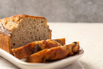 Pieces of banana bread on light grey table, closeup