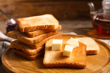 Slices of tasty toasted bread with butter on table, closeup
