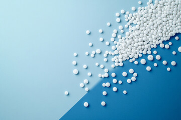 Blue and white background with scattered medicines, creating associations with pharmaceuticals and medical research