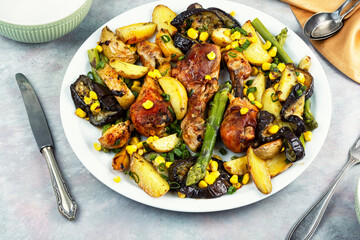 Roast chicken thigh garnished with vegetables.