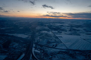 An aerial view at dusk over a snow covered city of Calgary in Alberta, Canada