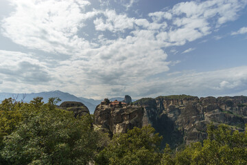 Fototapeta premium Famous rock formations of Meteora with Holy Trinity Monastery building on top of the rocks, Kalambaka, Thessaly, Greece