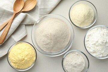 Different types of flour on white background, flat lay