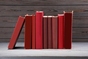 Many old books on grey wooden table