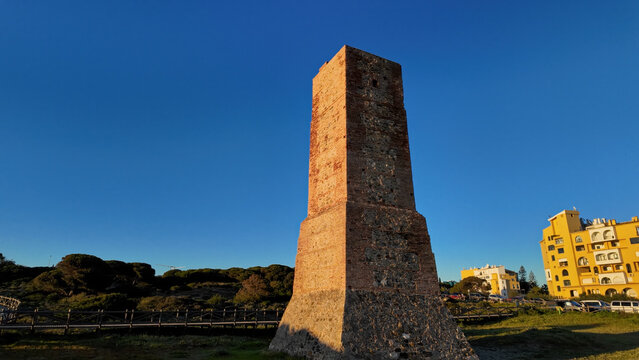 Torre Ladrones illuminating Marbella Coastline during Golden Hour Sunset