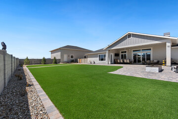 A spacious house featuring a large lawn area located right in front of it