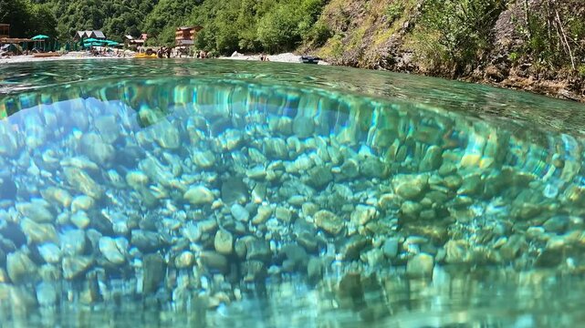 Beautiful rock or pebbles background. Beautiful round rocks in the crystal clear water background. Shala river, Albania
