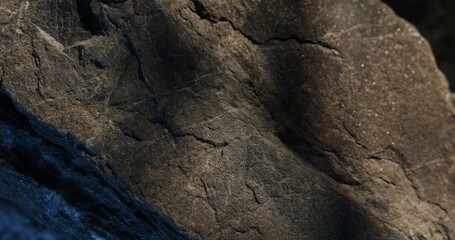 Textured Rock Surface with Blue Shadows and Light Contrast