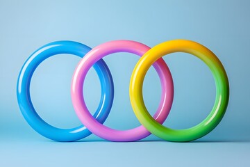 Three colorful plastic rings are stacked on top of each other. The rings are of different colors and sizes, creating a visually appealing and playful arrangement. Concept of fun and creativity