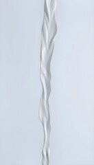 tall white vase sitting on top of a table