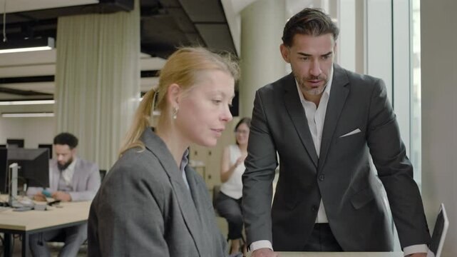Modern busy office scene shows diverse business people collaborating on projects, highlighting teamwork, creativity, and inclusivity in a modern workspace that fosters productivity and innovation