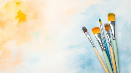 Yellow and blue watercolor background with brush strokes, artistic paper texture mockup, flat lay mockup with painting tools, brushes, and copy space