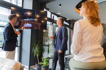 Business Team Analyzing Financial Charts in Modern Office Meeting