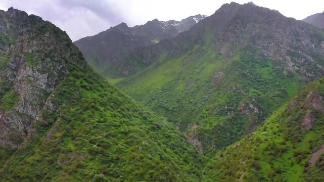 A breathtaking drone shot showcases the vast, snow-capped mountains of northern Pakistan, part of the majestic Karakoram, Hindu Kush, and Himalayan ranges.