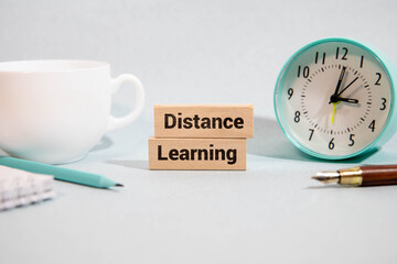 Open laptop with isolated white screen on old wooden desk with text ONLINE LEARNING.