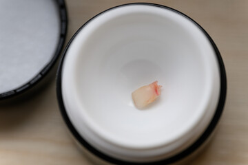A baby tooth placed in a box.

