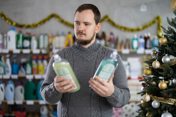 On Christmas Eve, man gets acquainted with assortment, choose dishwashing soap new products. Client...