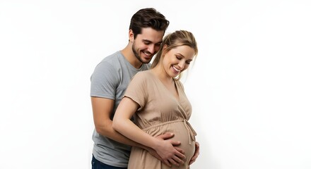 Fototapeta premium A smiling couple embraces, with the husband gently cradling his pregnant wife's belly.