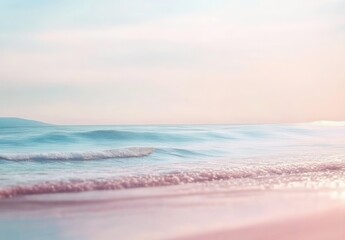 Blurred sandy beach with gentle waves and pastel sea colors, creating a soft and dreamy summer vacation background concept