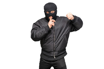 Masked man gesturing silence while preparing to punch