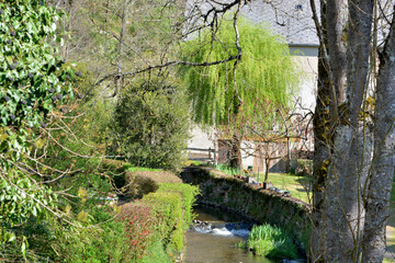 Moulin niché dans écrin de verdure avec ruisseau