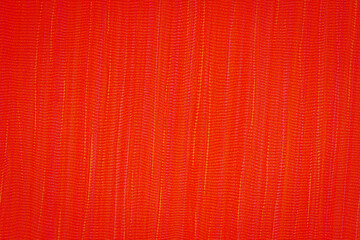 Fototapeta premium Bright red fabric displays a complex texture and pattern, ideal for artistic projects or fashion design applications