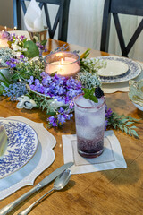 Blackberry and gin cocktail on a fancy spring lilac table