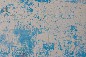 Peeling paint on the wall. Old concrete wall with cracked flaking paint. Weathered rough painted...