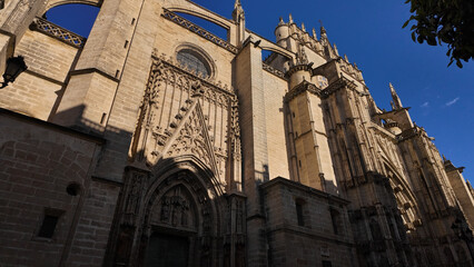 Seville Cathedral showing its gothic architecture under blue sky