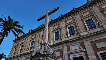 Large cross standing in front of the Archive of the Indies in Seville, Spain