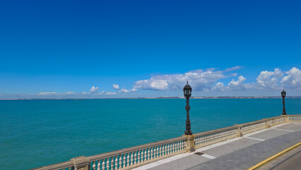 Cadiz seafront overlooking the Bay of Cadiz on a sunny summer day with turquoise water and blue sky