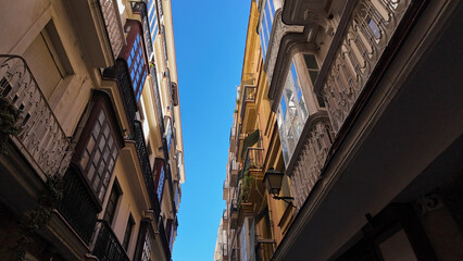 Traditional architecture of Cadiz, Spain, featuring balconies and clear sky