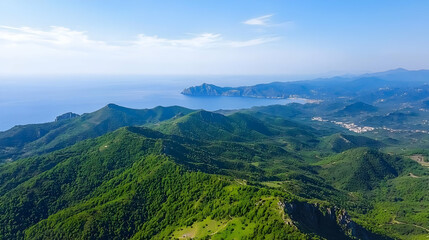 Fototapeta premium High Angle View Of Lush Green Mountains And Coastal Ocean