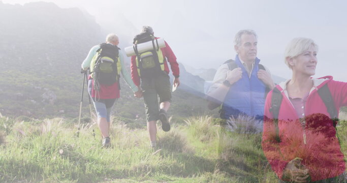 Fototapeta Composite of two happy caucasian senior couples hiking in countryside