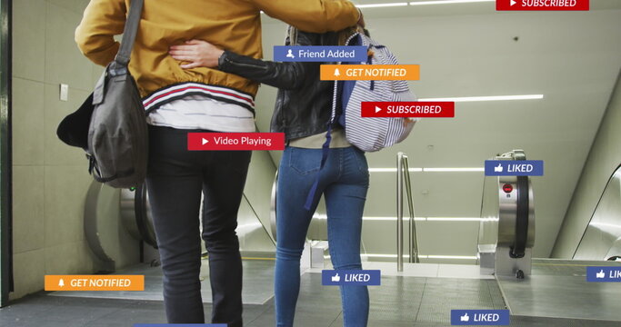 Image of social media icons floating over couple embracing on escalators - Powered by Adobe