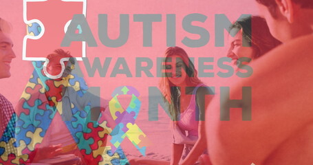 Image of colourful puzzle pieces and autism text over happy friends at summer beach party