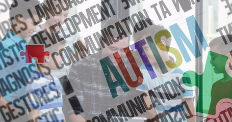Image of colourful puzzle pieces and autism text over school children with male teacher