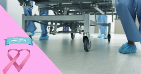 Image of pink breast cancer ribbon over group of working doctors