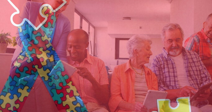 Image of colourful puzzle pieces ribbon over senior friends using tablets - Powered by Adobe