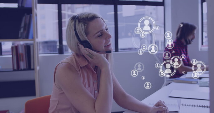 Image of media icons over caucasian business people using phone headsets - Powered by Adobe