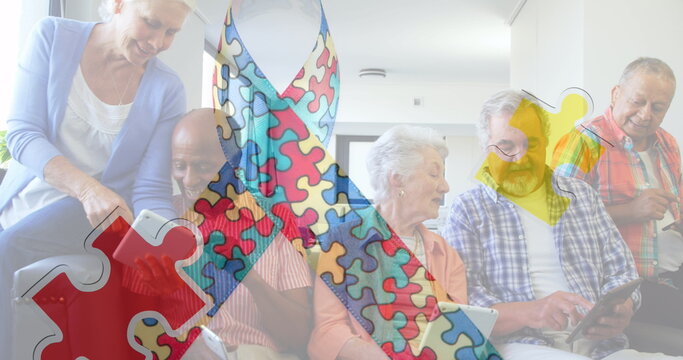 Image of colourful puzzle pieces ribbon over senior friends using tablets