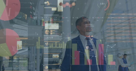 Image of financial data processing over diverse business people walking in modern office