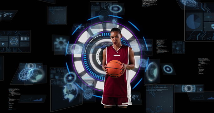 Image of african american female basketball player over scope scanning on black background