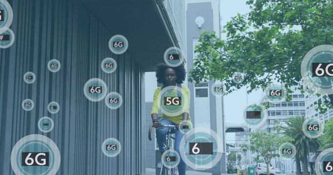 Image of 6g icons over african american woman riding bike in city street
