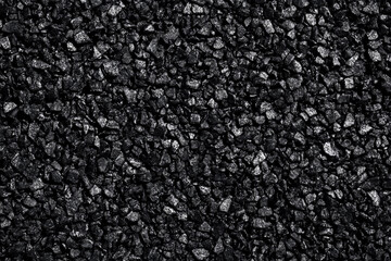Close-Up of Black Crushed Stones with Shiny Surface Texture
